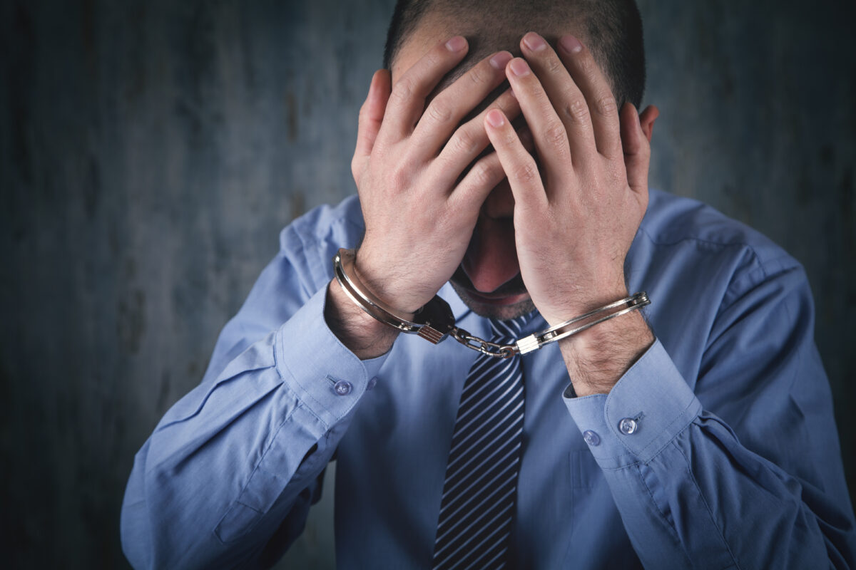 Caucasian businessman in handcuffs. Corruption.