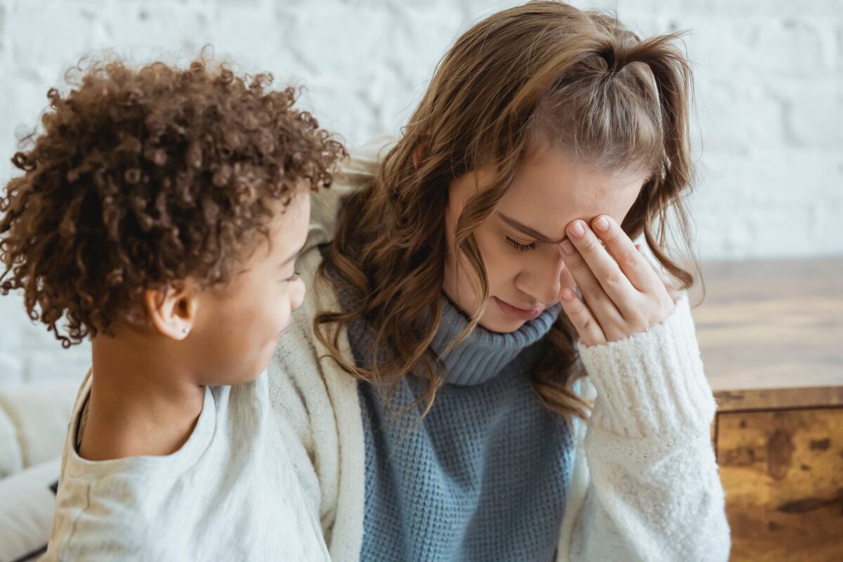 A woman is hugging her son, expressing worry.