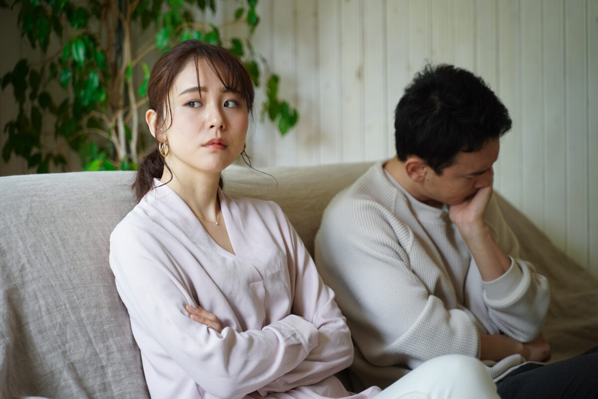 Worried couple sitting on couch