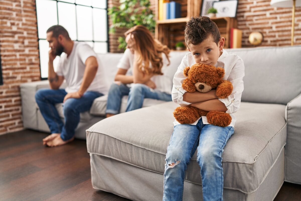 Family sitting on sofa and kid sad for parents argue at home