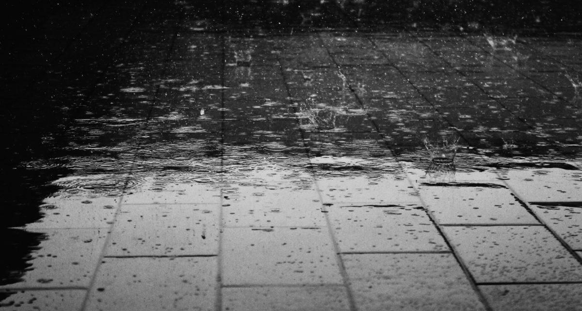 An image of an outdoor floor with raindrops falling.