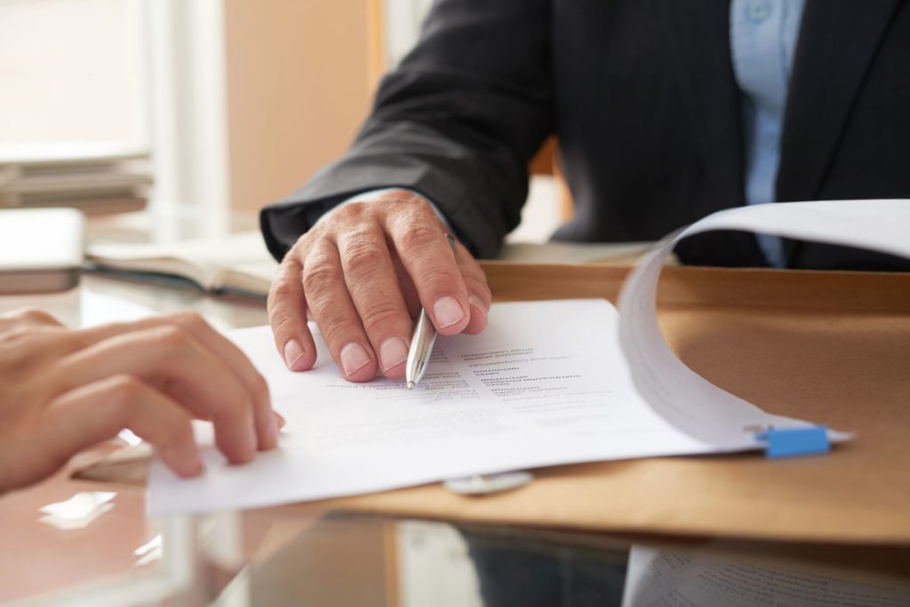 A person signing a document.