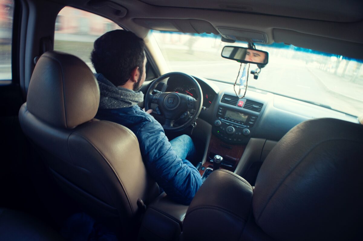 A man driving his car.