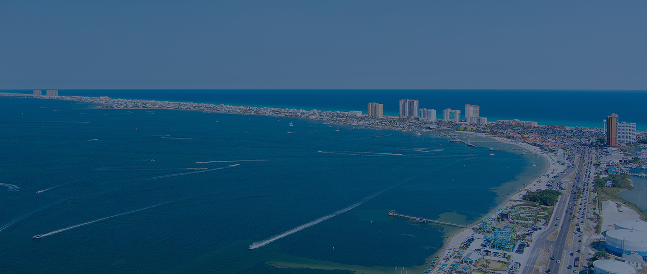 Aerial view of ocean and city buildings